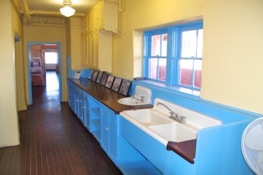 The long and narrow kitchen, quite a different layout than the typical "pass through" window system. Part of this room, toward the camera and outside door, is much wider to allow for a preparation table or two.