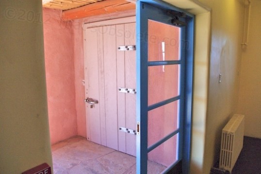 The kitchen entrance (the blue door) is flanked outside by a walk-in freezer installed to service the kitchen.