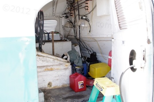 Between the cabin and the engine is this storage cavern. Wonder how many stacking storage bins you could jam in here if you wanted to...