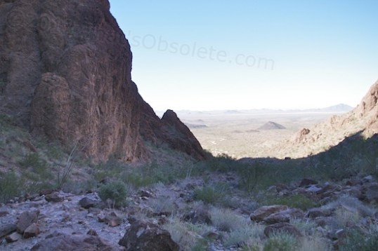 Turn around on your way in, and you can see the vast expanse of open desert outside the Canyon's entrance. Our car and the parking area are waaaaay down there!