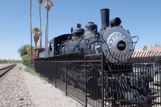 This locomotive and caboose are parked just to one side of the train station, and both date from about 1900. The fence is regrettable, but today, necessary.
