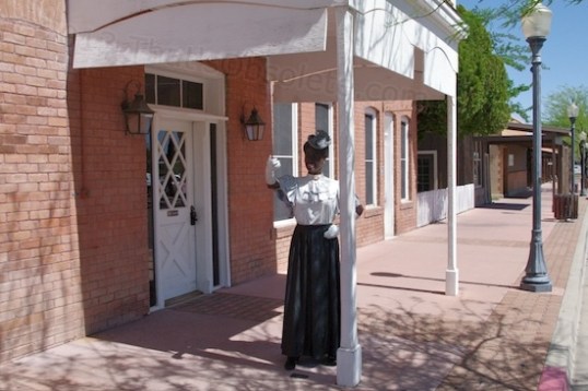I wondered about this until I looked it up. This is a depiction of Elizabeth Smith, who originally began the Vernetta Hotel in 1905, which catered to railroad passengers and primordial tourists to Castle Hot Springs and Wickenburg. She came from out East, and had James Creighton design and build it. It's now offices for Remuda Ranch and is called the Hassayampa Building.
