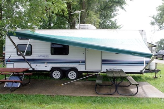 The awning in the "wind & rain" position. It helps a little with wind, and a lot with rain. And, if you're careful, you can still get the door partially open to get back in.
