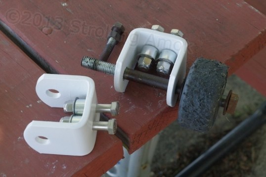 Instead of a bolt threading into the bracket and extending unsupported to the strap, I drilled out the treaded holes and rigged up bushings and lock nuts to keep them supported against side loads.