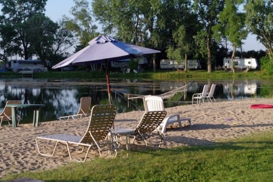 Walking past the "beach", complete with umbrella, loungers, paddle boats and algae-laden water.