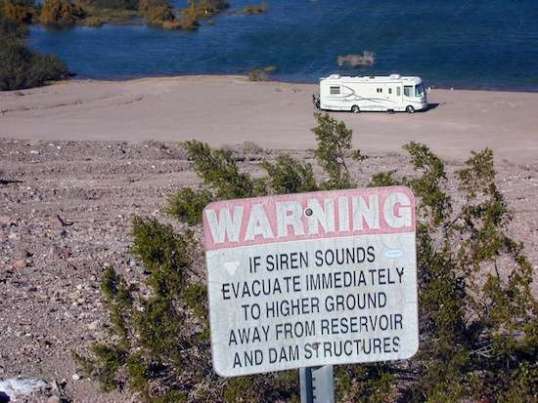 This sign made me wonder, but I'm told the water level can vary several feet within hours,  without the alarm going off. The sign makes the worst case sound bad, whatever that is.