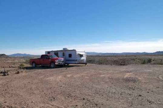 Actually, I managed to place the trailer on the only truly level few square feet of dirt on the entire pad, so I didn't need to add any boards under the tires.