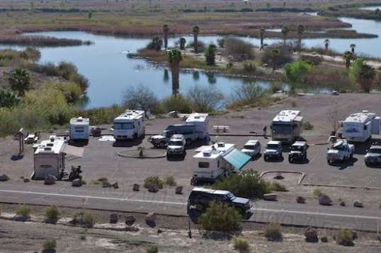 A strip for tow vehicle parking in the center trades maneuvering room for orderliness. Notice the pickup and TT at center.