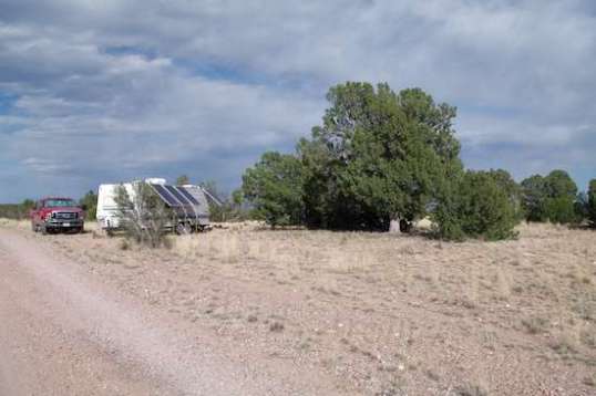 I had concerns about the truck's hot exhaust setting the ultra-dry tall grass on fire, but this site was the only bare spot for miles, and level, too! Those trees wound up not shading the solar panels due to the trailer's orientation and the sun's high arc. 