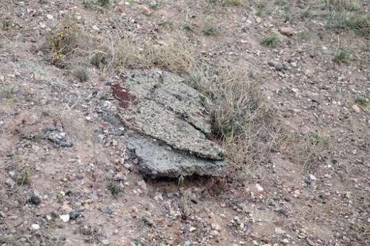 Remarkably little paving still exists. This two-layer chunk broke off and slid down the slope a bit. And, this was in an area that looked like it had never been paved.
