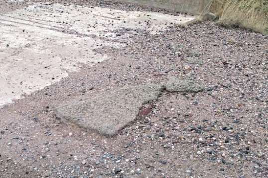 But close by, the first layer of pavement was level with the concrete, while the second was above it. Had the repaving topped the concrete surface?