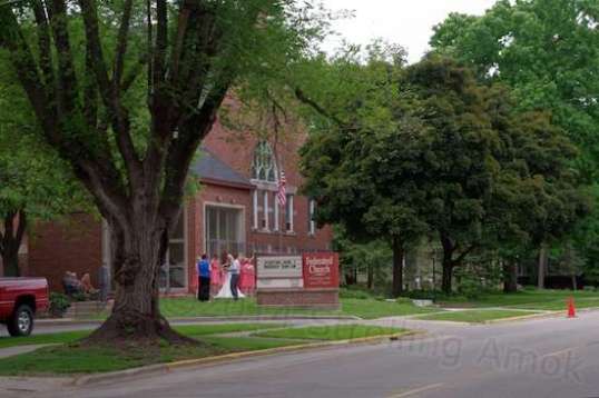 I didn't want to get close enough to intrude, but this was the photo session for a wedding. All the bridesmaids, nicely hidden by the sign, were wearing sort of a peach color.