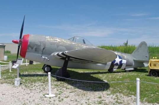 These always inspire an awed smile in me, if that's possible. This tubby devil is a P-47 Thunderbolt. Despite appearances and limited maneuverability, it was powerful, fast, well-armed, well armored, could climb 15,000 feet in five minutes, and could exceed 400 MPH at 28,000 feet altitude. Its nickname was The Jug - short for juggernaut. Later models such as this one featured a 13-foot propeller, and the landing gear could only safely reach out so far, so the pilot had to be careful to keep the tail down on takeoff and landing, to clear the prop. The prop's ground clearance was just 6 inches. As you can see from this photo, his view of the runway ahead was nonexistent. Training manuals cautioned not to throttle up too quickly on takeoff, since the power turning that massive propeller could twist the craft off course as well as force it to rotate sideways. All such later, high-performance fighters had similar nasty traits that could turn around and bite you if you treated them too casually. 