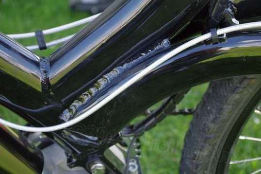 The junction of four major unsupported tubes requires welding that spans a large area, in order to try to distribute the bending stresses.