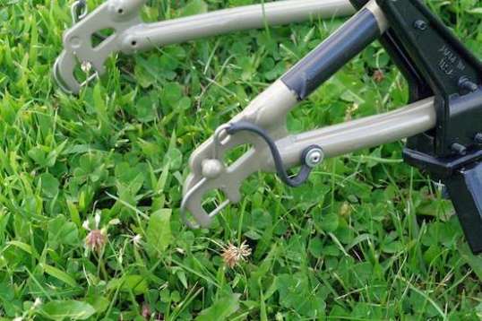 That little curved pin slides into the frame arm through tiny drilled holes, locking the axle bobbin into place. There's not much material here, but they do the job and lock into place.