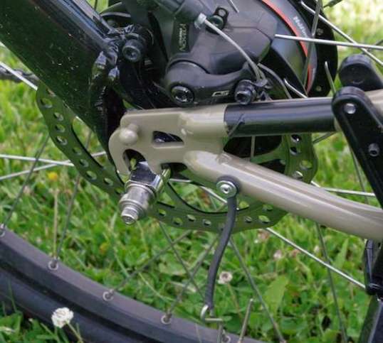 Exciting, no? You put the arm into place and yank it outward to go over the bobbin. Don't try this with a loaded trailer.