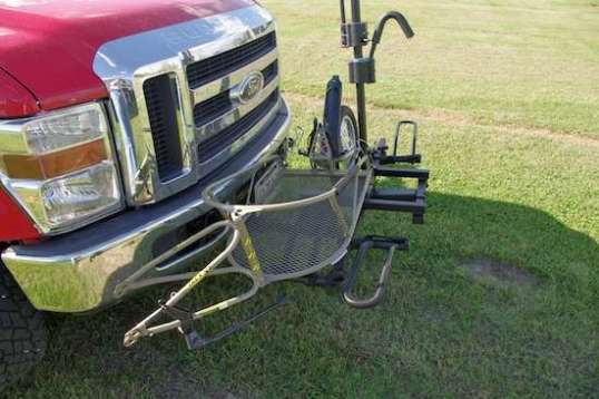 Setting the 20-pound Ibex in place is easy, and its tire drops deep through a platform loop. But notice that more needs to be done to anchor both the trailer body and its rotatable front fork, which wants to swing into the Ford's bumper.