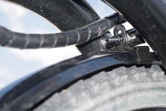 The front end of the fender is held well enough by this plastic support that can be bolted to the Aurora's crossmember. It's left in place so that the fender can just be slid into it, and strapped on.