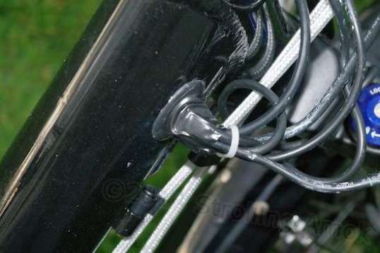 My hope is that drooping the wires down and wrapping the rubber seal entry point with tape will discourage rain entry into the frame.