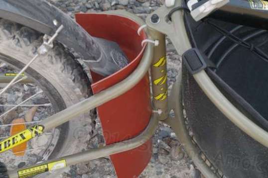 Rude 'n crude, this rubber flap to protect the trailer works, and doesn't interfere with the Planet Bike fender.