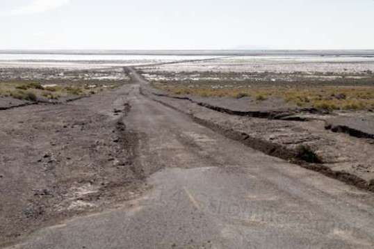 This is looking down the same grade, from fairly near the top. Although this is Sunday, some kind of smaller vehicle with a blade has cut down a path to the pavement.