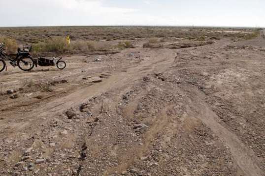 Leppy Pass' shoulder at the secondary exit, which meets it at a 45-degree angle. The bike is parked along this exit road. Almost unnoticeable in the truck. this area would ground the trailer's skid plates, at best, as it crossed. Doesn't look like it in the photo, but on foot, yup. And I've grounded it in places I thought it would clear, so if anything, I tend to be optimistic on this kind of thing.
