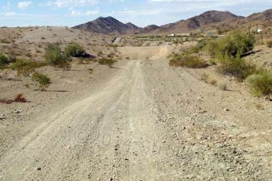 Starting out on this BLM trail looks pretty promising, since it's wide and smooth. The little white box ahead is a semi-trailer on I-10.