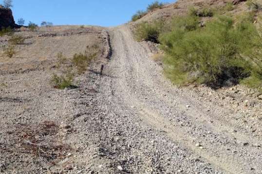 Ummmm, no. Not going to happen. The few yards of dirt near me goes to loose gravel and rocks from there on up. I made it up halfway before my front tire shifted to one side on a rock and forced a stop. It wasn't as it it had been going well up to that point, either. What a mess!