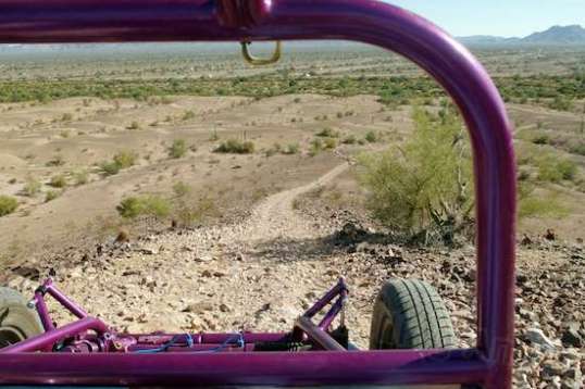 This is the descent from that same hilltop, and it's steeper than it looks here. I had concerns that the vehicle might slide, since the loose roughness would be a challenge for my e-bike, but it was no problem.