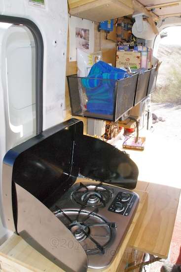A kitchen and work table occupy the passenger side.
