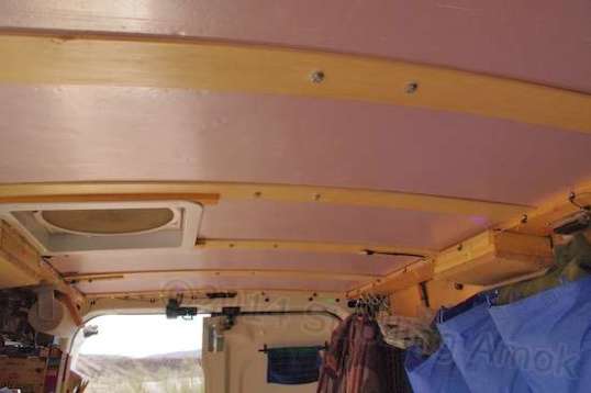 Those stringers across the roof support a sheet of foam insulation, and the bolts at center go neatly into factory mounts intended to hold a special internal ladder rack.