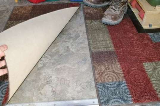 Richard put insulation on the floor and took the advice of the sales lady when laying down the self-stick vinyl floor squares: he secured them with his own adhesive. No problems so far.