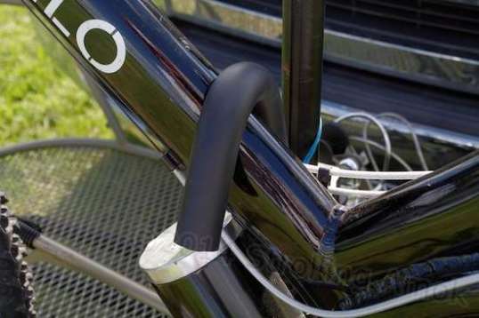 The padded hook goes down over the bike's frame to keep it upright and deep in the wheel hoops.