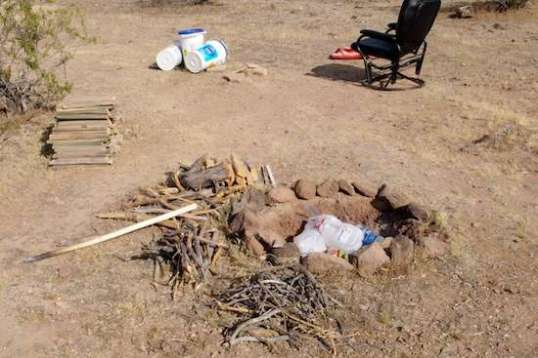 At least he was considerate enough to leave plenty of wood neatly stacked so the next camper to arrive could burn his trash for him. 