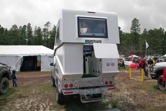 One model of XP Camper uses a hinged clamshell to allow a pop-up's air drag and CG advantages with the protection and insulation of a hardwall truck camper.