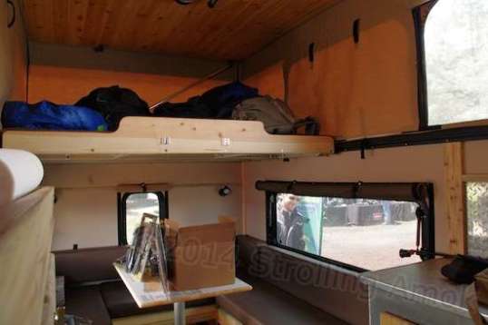 Stepping in reveals a sleeping platform above too, justifying the generous dining area.