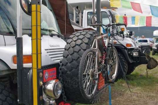 Unimogs are extreme-conditions trucks owned by Mercedes. The frame just to the rear of the cab is articulated to allow much more twist than any suspension could handle. They are claimed to be able to get over a yard-high boulder, so long as you don't add stuff underneath. This limits their load capacity, but they are the ne plus ultra of 4x4 off-road trucks, and the debate over that is zero.