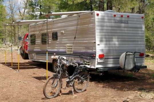 Back at camp, the Mighty Defiant is ready for some gnarly rock-crawling and stream fording, oh yes. well, at least the Aurora e-bike is. It's just coated with mud from the show!
