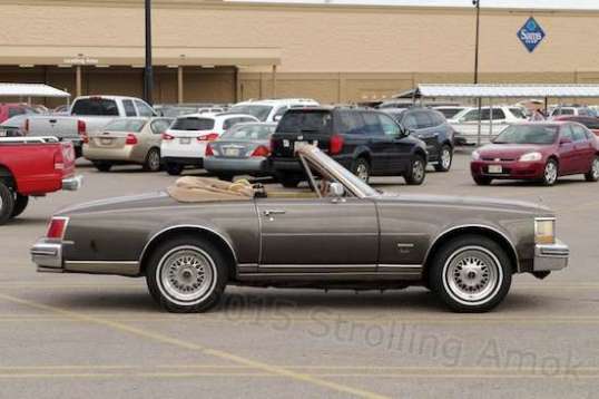 At a Sam's Club in Nebraska, I looked out the camper window to see an old Cadillac Seville convertible with wonky proportions.