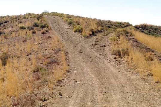 For me, the end of the line. It likely loops around the hill top. Where I'm standing is the supposed start of the branch into town that the online map indicates. It's pretty steep, there's nothing there, and it looks like there never was. No trail scars, no erosion, no nothing.