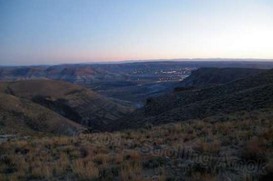 The town begins to light up like a Christmas tree, and in the darkness, the distance makes them all twinkle.