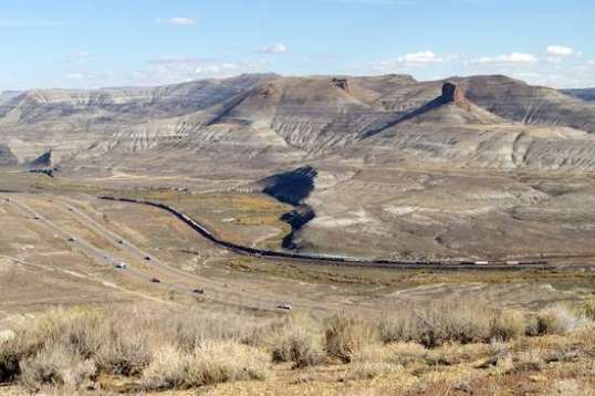 Top of the world! I-80 and dual railroad tracks lead to Green River, on the right. Too distant to hear, those tracks are the busiest I've ever seen. The surrounding terrain makes all the activity seem very limited.