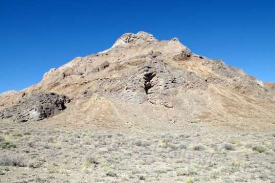 This mountain has one section which is beginning to break apart, spilling its boulders below.
