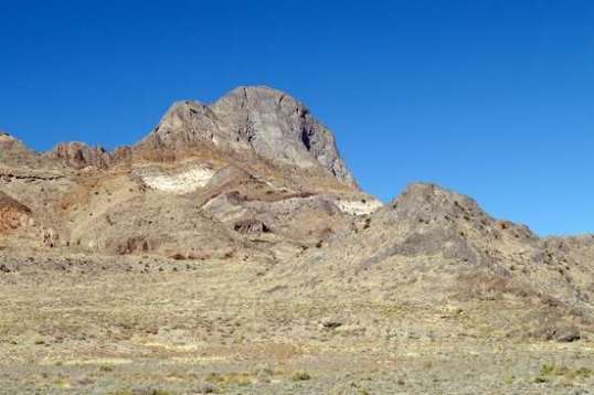 A tall blade of solid rock stays put.