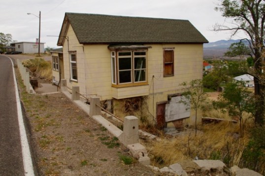 Here's an interesting home that's being rehabbed, right alongside Business 93. No access to speak of in back, and the only place to park up front is a pull-off further ahead. Not the easiest, cleanest rehab job you'll ever see.