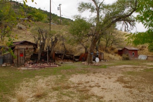 Here's a "vacant" property along a main drag that has a power box and water supply for an RV at center, and a shack-covered mineshaft at each end! Rockhounds Gone Wild!