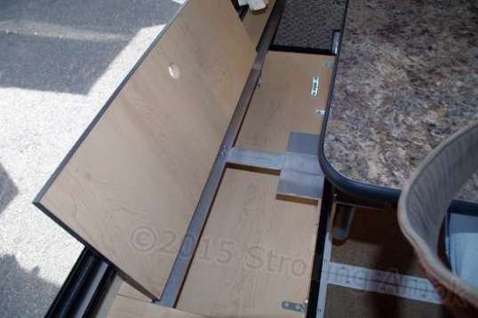 The center of the forward wall has a flat little tray for at least 800 pencils. This is right over the top of the water tank, and that odd-looking aluminum piece at center is to support the lid when you use it as a step up into the bed.