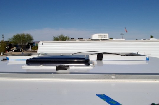 and this shot from the passenger side shows that the panel can't afford to be moved forward very much. Taper near the roof edges and aerodynamic pressure at speed will test the mettle of any panel mounted with adhesive. These are monocrystalline panels, which are the only type narrow enough to fit in this position.