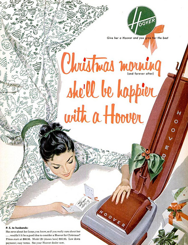 Title: "Christmas morning (and forever after) she'll be happier with a Hoover". Copy: "P.S. to husbands: She cares about her home, you know, so if you really care about her...wouldn't it be a good idea to consider a Hoover for Christmas? Prices start at $??.??. Model 29 (shown here) $??.??. Low down payment; easy terms. See your Hoover dealer now."