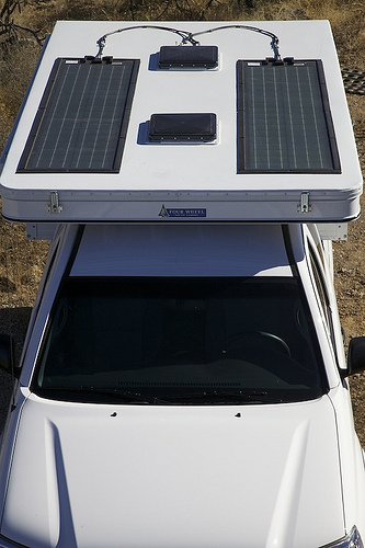 Here's a 200W system based on two flexible Global Solar panels adhered to the roof. They are pricey and relatively inefficient, but work. Note that this FWC has its vents centered, something I didn't know could be ordered.